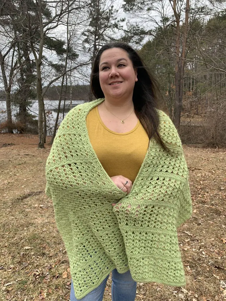 Trista from Crochets By Trista modeling the crocheted "Lettuce Wrap" in a wooden landscape